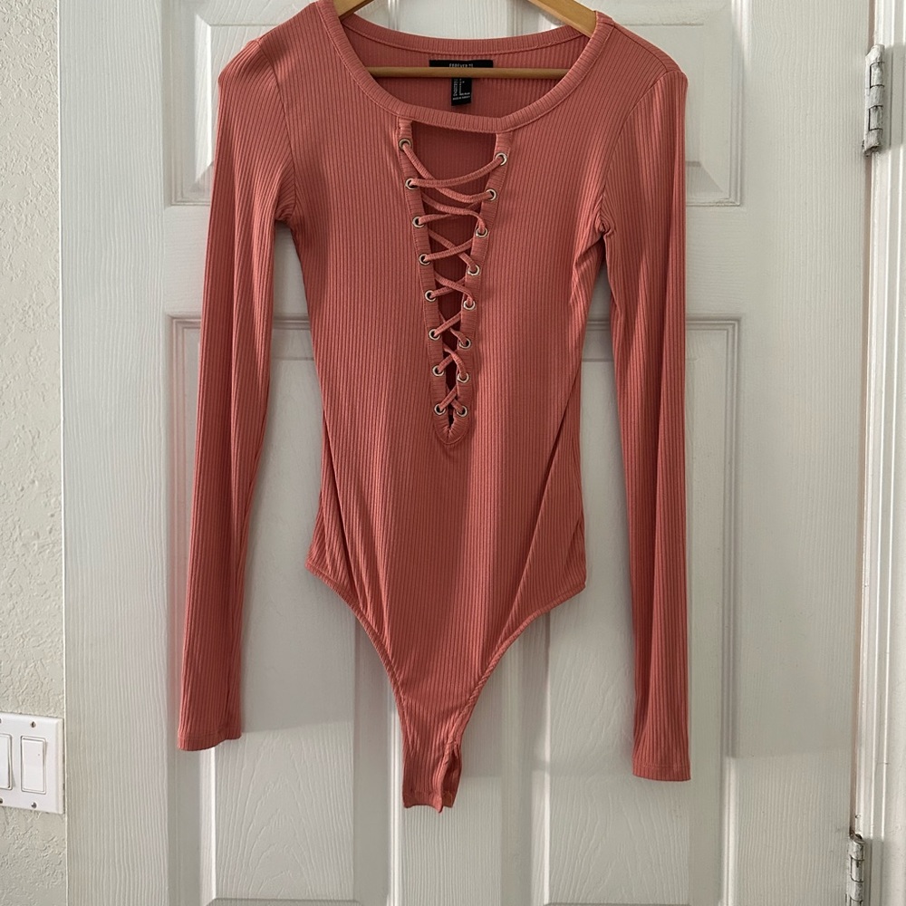 Peach colored bodysuit with open tie neckline